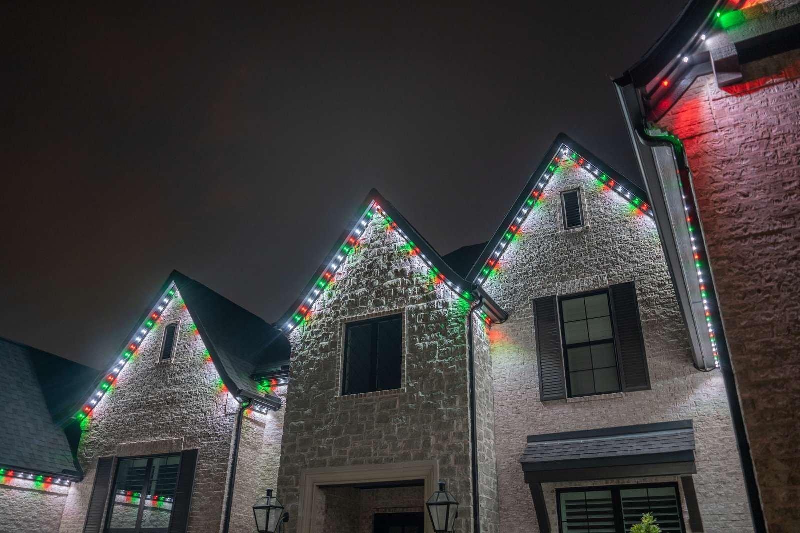 Close-up of multicolor holiday lighting on the same trim